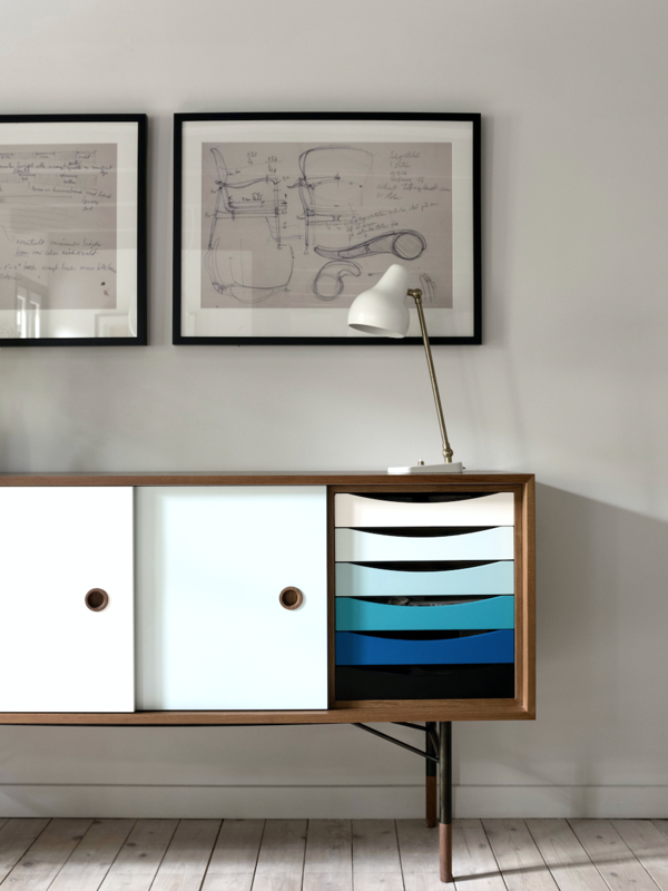 The Sideboard in walnut with sliding doors in white and light blue and trays in the cold color scheme.