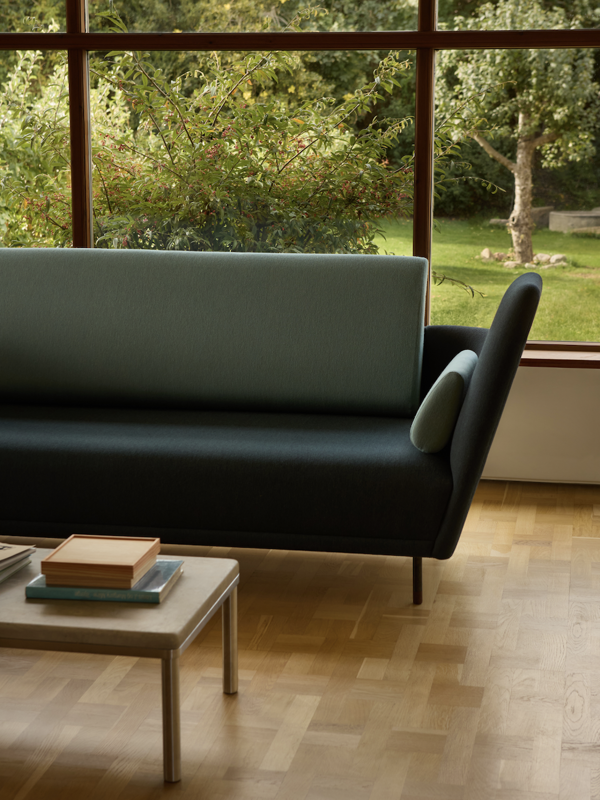 The 57 Sofa with 'Watercolour' upholstery in the colour 'Dark Conifer' on the body and the colour ''Himalaya'' on the back and cushions.