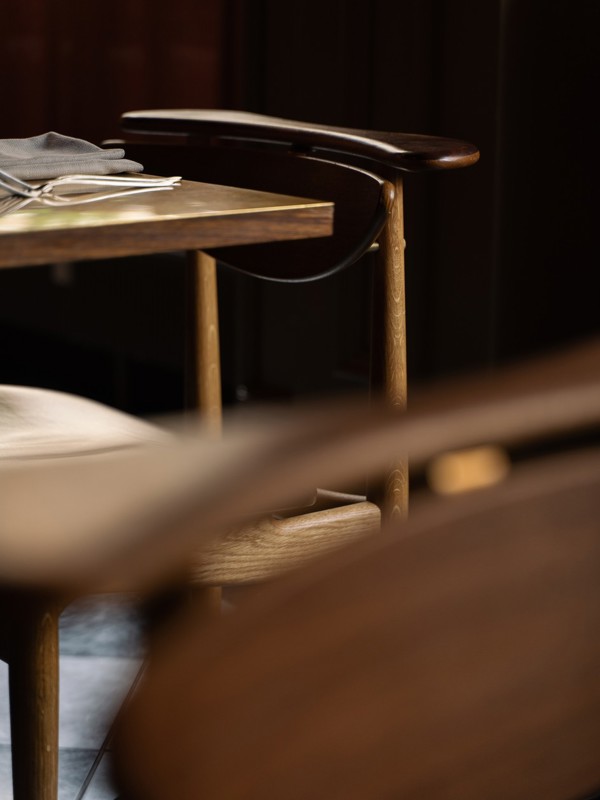 The Reading Chair in oak and walnut with a black contract grade leather at Restaurant Palægade.