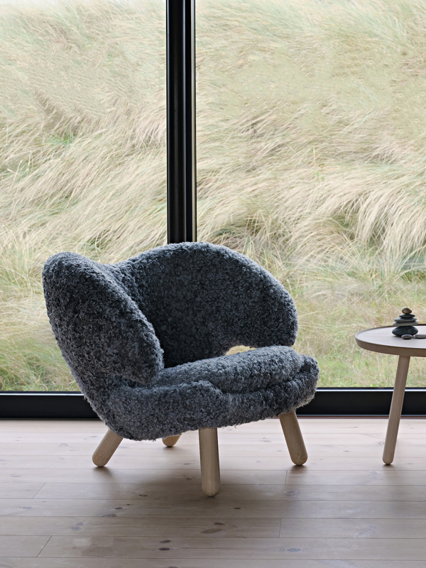 The Pelican Chair with legs in oak (clear oil) and upholstery in sheepskin from Gotland.