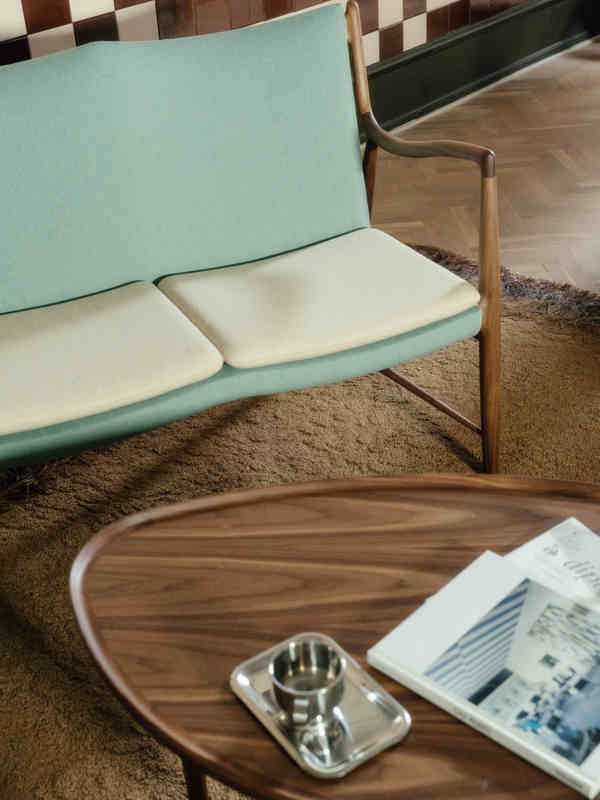 The 45 Sofa in walnut with upholstery in 'Watercolour', in the colors 'Himalaya' and 'Soft Linen'.