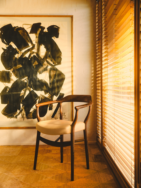 The 44 Chair in walnut with 'Vegetal' leather upholstery in the colour '90'.