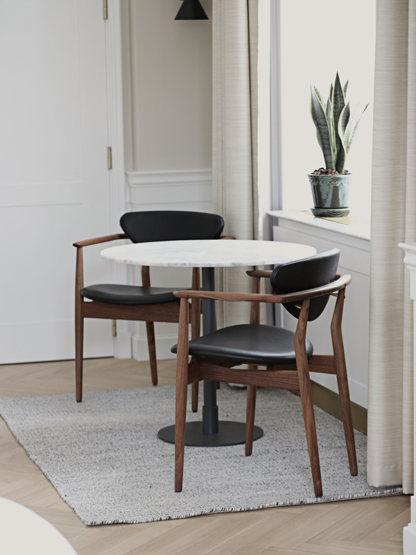 The 109 Chair in walnut with 'Elegance' leather upholstery in the colour 'Black'.