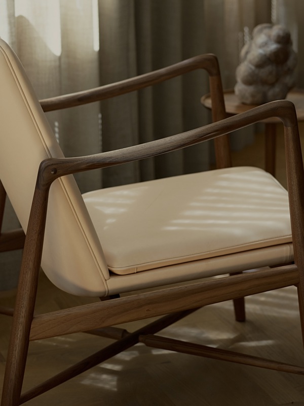 The Fireplace Chair in walnut with 'Vegetal' leather upholstery. 