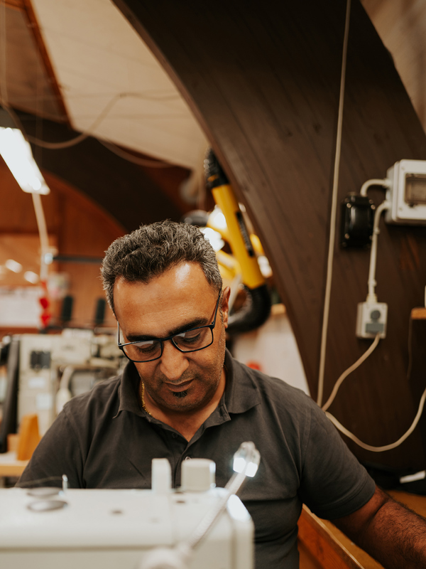 Faeiq's daily tasks span from precise cutting to meticulous sewing and upholstery work.